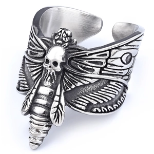Detailed macro view of vintage silver gothic moth skull engraving on stainless steel ring