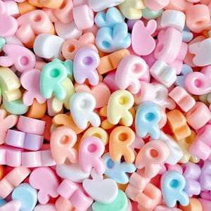 Macro shot of colorful resin letter R beads for DIY hair clips and jewelry making