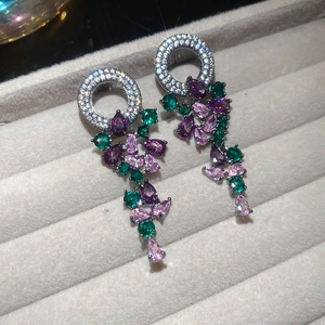 Macro shot of colorful pear-cut zircon stones on silver tassel earrings with high brilliance