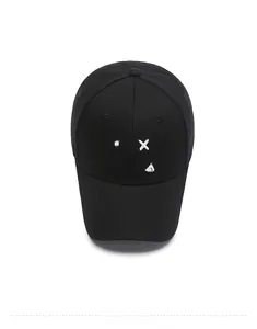Detailed top view of a black cotton baseball cap with a white embroidered smiley face