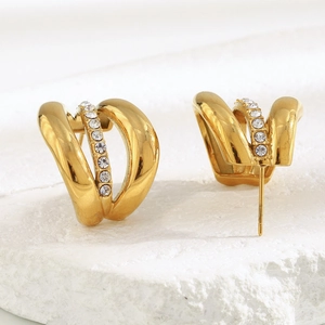 Macro view of 18K gold-plated triple-layer stud earrings with inset cubic zirconia stones