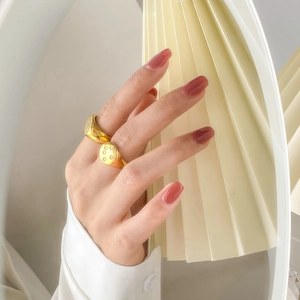 Detail of two gold hexagram star rings with inlaid cubic zirconia on a female hand