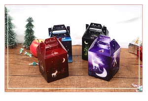 Close-up of four colorful Christmas gift boxes with holiday patterns on a wooden table