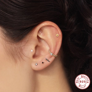 S925 sterling silver flower and star stud earring set with zircons shown on model ear