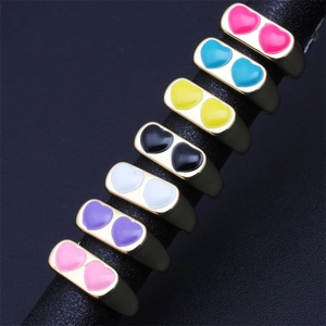 Colorful 18K gold-plated star rings with vibrant enamel set on a premium display stand