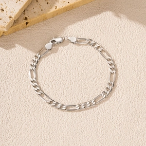 Minimalist S925 sterling silver Figaro chain bracelet with lobster clasp on a stone background
