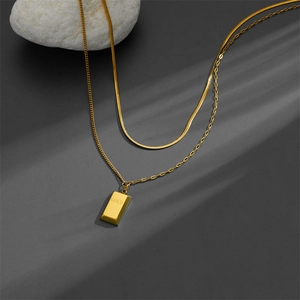 Elegant gold double-layer titanium necklace with flat snake chain and a GOLD bar pendant