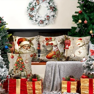 Set of four vintage Christmas pillow covers with Santa and tree motifs on a bench