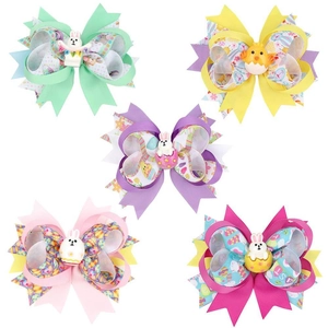 Detail of five colorful Easter hair bows with resin rabbits, eggs and chicks decorations