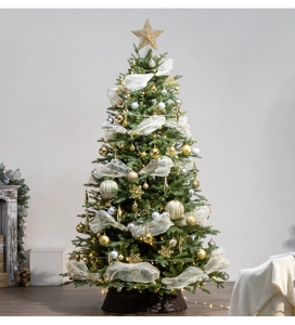Detailed close-up of a lit Christmas tree with gold ornaments and warm LED lights
