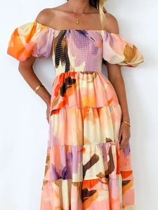 Detail of off-shoulder puff sleeves and shirred bodice on floral tiered maxi dress