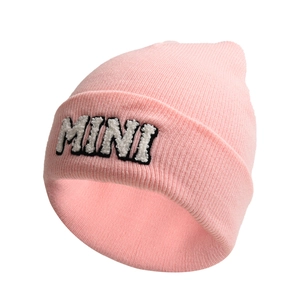 Detailed close-up of pink knit beanie featuring MINI letter embroidery on the cuff