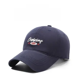 Detailed close-up of Champions embroidery and twill cotton fabric on navy baseball cap