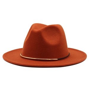 Classic burnt orange wool fedora hat with a gold metal bar and black decorative band