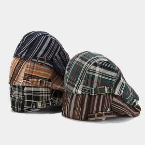 Collection of plaid and striped flat caps with vintage metal buckles in assorted colors