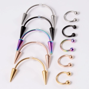 Set of ten stainless steel horseshoe rings in five colors with cone and ball spikes