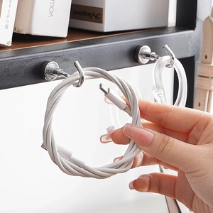 Heavy duty magnetic hook on metal surface organizing white USB cables for home storage