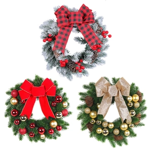 Three Christmas wreaths with pine cones and decorative bows on a white background