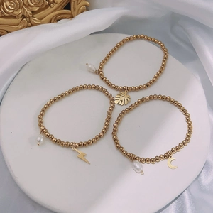 Minimalist 18K gold plated beaded bracelets with leaf, lightning, moon, and pearl charms
