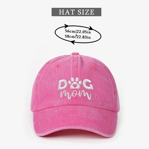 Detail showing embroidered DOG MOM text and paw heart logo on pink washed cotton baseball cap