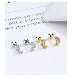 Detail of 925 sterling silver crescent moon stud earrings with zircon and screw backs