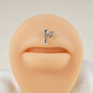 Detailed view of silver axe-shaped nose stud with sparkling crystals on silicone model