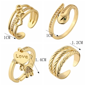 Detail view of golden fashion rings set including heart, snake and love motifs