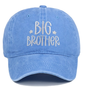 Macro detail of Big Brother white embroidery on a washed blue vintage baseball cap
