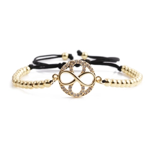 Minimalist gold infinity bracelet with sparkling zircons and adjustable black cord