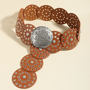 Detail of vintage carved silver buckle and brown leather studded round links belt