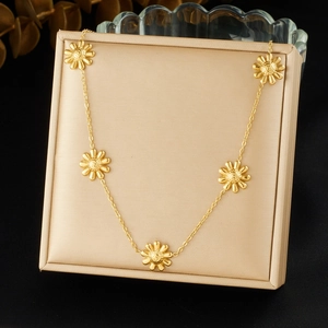 Minimalist gold-plated stainless steel sunflower necklace set in a beige jewelry box