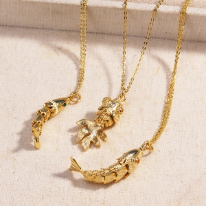 Three elegant gold-plated koi fish pendant necklaces made of durable titanium steel