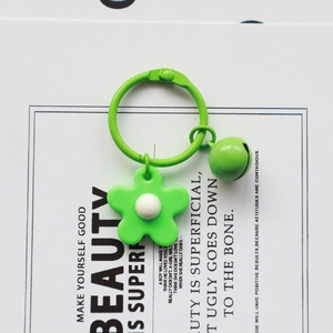Handmade knitted bright green flower bell keychain on white paper with quotes