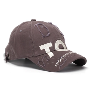 Close-up of vintage brown cotton baseball cap with 3D TO embroidery and distressed ripped details