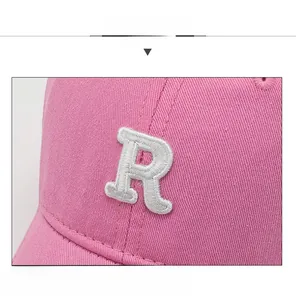 Close-up of pink cotton baseball cap featuring premium white 3D embroidered letter R
