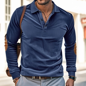 Detail of blue corduroy polo shirt with brown elbow patches and visible ribbed texture