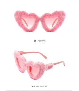 Detailed front and 45-degree side view of pink fuzzy heart-shaped party sunglasses