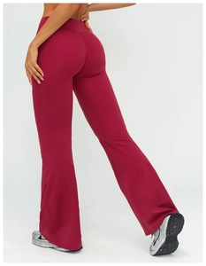 Detail view of high-waisted flared yoga pants in burgundy with elastic back fit