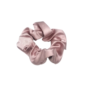 Minimalist pink satin oversized scrunchie with elegant silk gloss on white background