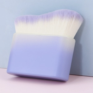 Macro view of wide wavy makeup brush with purple gradient bristles and matte handle