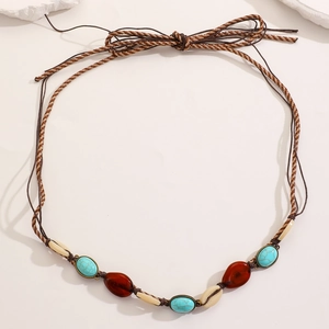 Detail of woven Bohemian waist chain with turquoise beads, amber stones and sea shells