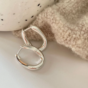 Minimalist 925 sterling silver curved oval hoop earrings with a polished silver finish