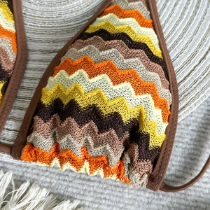 Close-up of crochet halter bikini top with earth-tone chevron stripes and knit texture