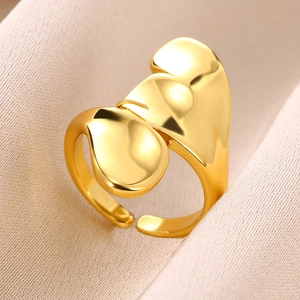 Macro shot of polished gold-plated snake-style ring with fluid wave design details