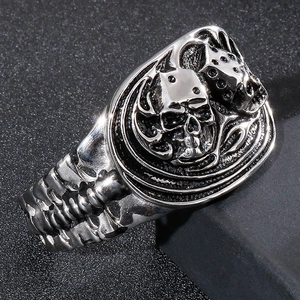 Macro shot of vintage silver skull ring with dice and skeleton rib texture