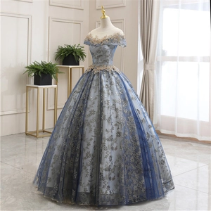 Detailed embroidery and gold lace sequins on a blue grand evening gown bodice