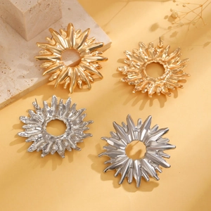 Macro shot of textured gold and silver sunflower stud earrings with irregular hammer finish