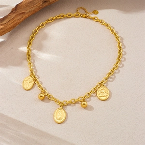 Gold plated stainless steel chain necklace with cross and coin pendants on beige background