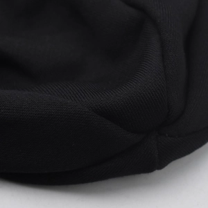 Close-up of black knitted cotton fabric showing plain weave texture and fine stitching