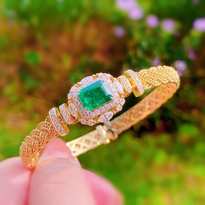 Italian vintage woven gold bracelet with emerald gemstone and sparkling diamonds